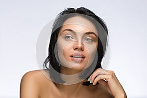 Beauty Portrait. Beautiful Spa Woman Touching her Face. Perfect Fresh Skin. Pure Model. Youth and Care Concept