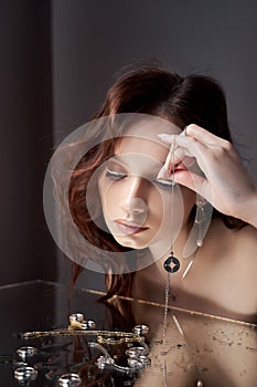 Beauty portrait beautiful woman, mirror reflection. Natural makeup, jewelry rings on your fingers