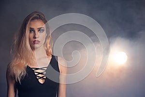 Beauty portrait of a beautiful young caucasian woman over smoky background