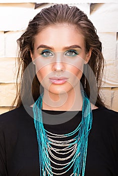 Beauty portrait of beautiful young woman in black. Professional makeup and wet hair