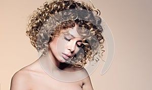 Beauty portrait of beautiful young woman with closed eyes. Hairstyle with curly hair