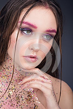 Beauty portrait of beautiful young woman with wet hair. Bright professional makeup