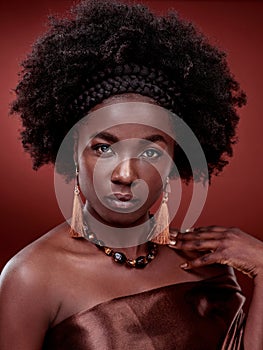 Beauty, portrait and black woman with fashion in studio isolated on a red background. Face, makeup cosmetics and serious