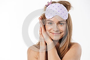 Beauty portrait of blonde half-naked woman wearing sleeping mask smiling