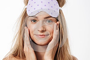 Beauty portrait of blonde half-naked woman wearing sleeping mask smiling