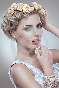 Beauty portrait of bride with roses wreath in hair