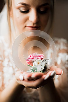 Beauty portrait of bride wearing fashion wedding dress with feathers with luxury delight make-up and hairstyle