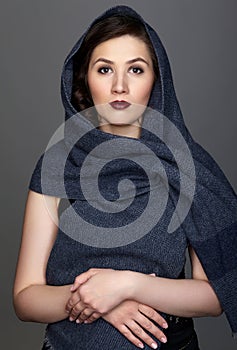 Beauty portrait of brunette woman dressed in dark blue scarf