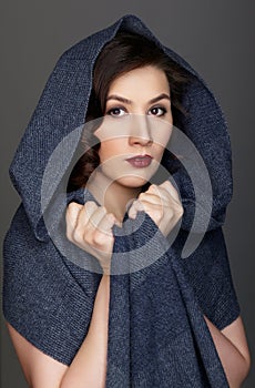 Beauty portrait of brunette woman dressed in dark blue scarf