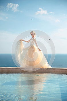 Beauty Portrait of gorgeous bride in wedding dress with blowing skirt