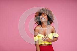 Beauty portrait of happy smiling african american girl with afro hairstyle and glamour makeup