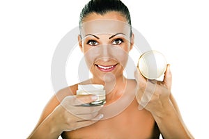 Beauty portrait of happy young woman applying creme