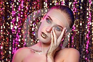 Beauty portrait of a High Fashion model woman in colorful bright neon lights posing in studio, night club On colourful