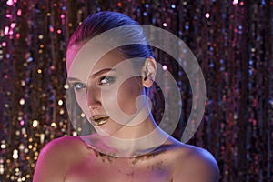 Beauty portrait of a High Fashion model woman in colorful bright neon lights posing in studio, night club On colourful