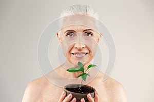 Beauty portrait of a joyful half naked elderly woman