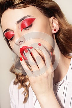 Beauty portrait of sexy women with glamour make up. Red lips and red eyeshadows, neils. Beauty fashion model face. Manicured hand