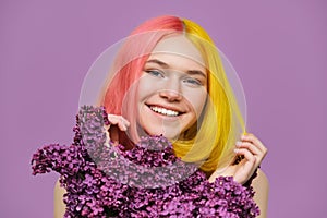 Beauty portrait of teen girl with fashionable dyed hairstyle, lilac flowers