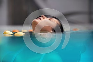 Beauty Portrait Underwater. Woman Floating In Pool With Citrus. Enjoying Freshness On Recreation At SPA.