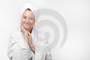 Beauty portrait of woman wearing a towel and white bathrobe