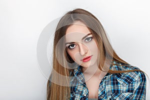 Beauty portrait of young adorable fresh looking blonde woman with hair chaos in blue plaid shirt. Emotion and facial expression co