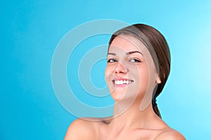 Beauty portrait of a young attractive half naked woman with perfect skin laughing and looking at camera isolated over