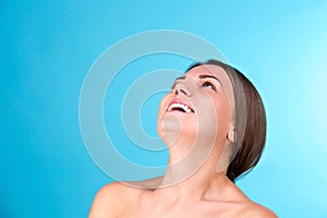 Beauty portrait of a young attractive half naked woman with perfect skin laughing and looking at camera isolated over