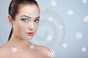 Beauty portrait of young beautiful woman over snowy