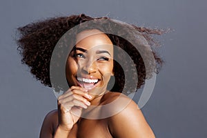 Beauty portrait of young black female fashion model laughing