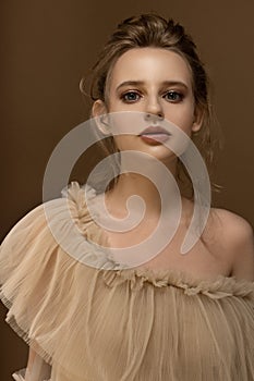 Beauty portrait of young caucasian model. Trendy fashion shot in golden tones.