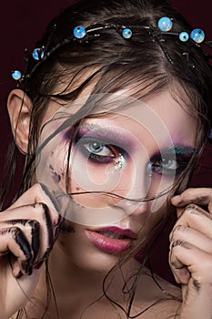 Beauty portrait of a young girl with fashion creative make-up