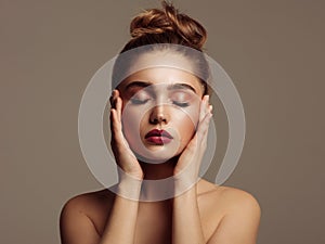 Beauty portrait of young girl touching her temples