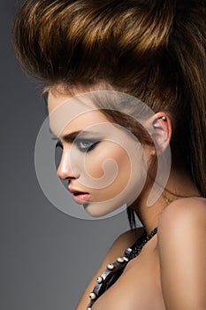 Beauty portrait of young glamorous woman with fashion hairdo