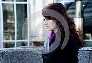 Beauty portrait of young woman with black eyeliner on urban background