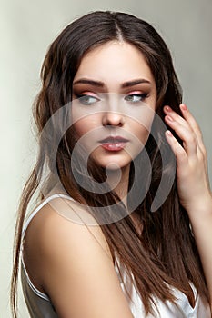 Beauty portrait of young woman. Brunette girl with evening female makeup