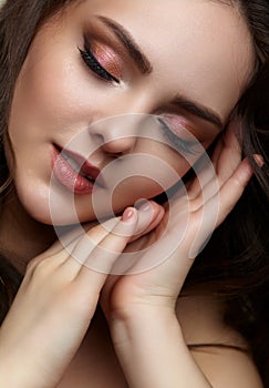 Beauty portrait of young woman. Brunette girl with evening female makeup and eyes closed