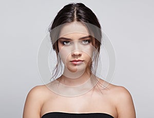 Beauty portrait of young woman on gray background