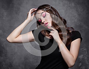 Beauty portrait of young woman. Brunette girl with evening female makeup and black T-shirt