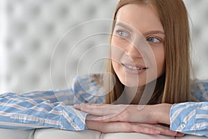 Beauty portrait. Young woman on grey wall background.