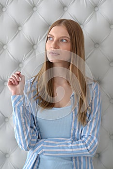 Beauty portrait. Young woman on grey wall background.