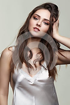 Beauty portrait of young woman in silk peignoir