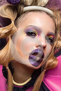 Beauty portrait of young woman wearing fashion dress with creative hairstyle and bright makeup.