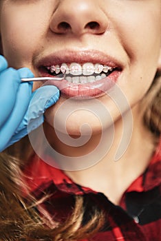 Beauty is power. A smile its sword. Teen at the dental office. Dentist examining girl`s teeth in clinic.