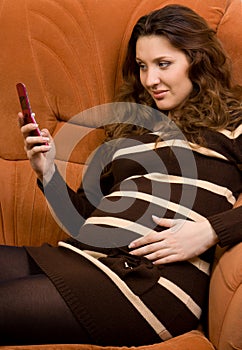 Beauty pregnant women reading sms