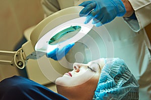 Beauty procedure. Facial skin examination