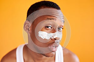 Beauty procedure and skin care, young manful man with face mask on around nose zone photo