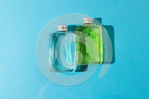 Beauty product bottles in water with copy space background on blue background