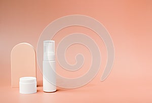 beauty product and mock-up skincare container on a pastel display background with copy space