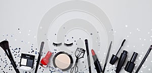 Beauty products and cosmetic for woman makeup decorated star confetti on gray table top view. Flat lay style. Banner format