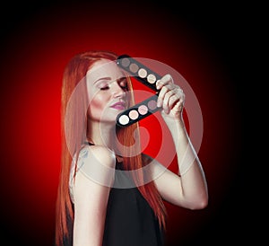 Beauty red head girl with makeup eye shadows