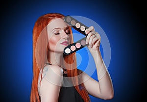 Beauty red head girl with makeup eye shadows